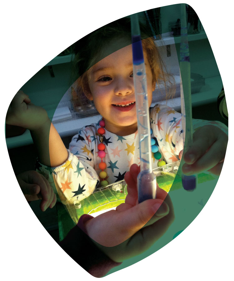 children playing at a light table